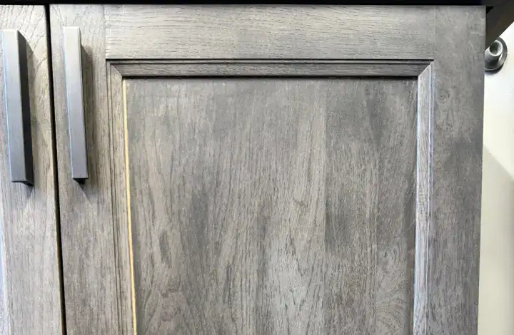 Gray wooden cabinet door with modern handle